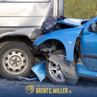 Blue car with front-end damage after a rear-end accident in Clermont