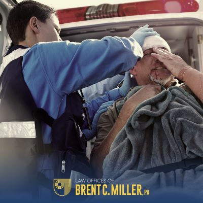 A paramedic assisting an injured man after an accident in Clermont, FL
